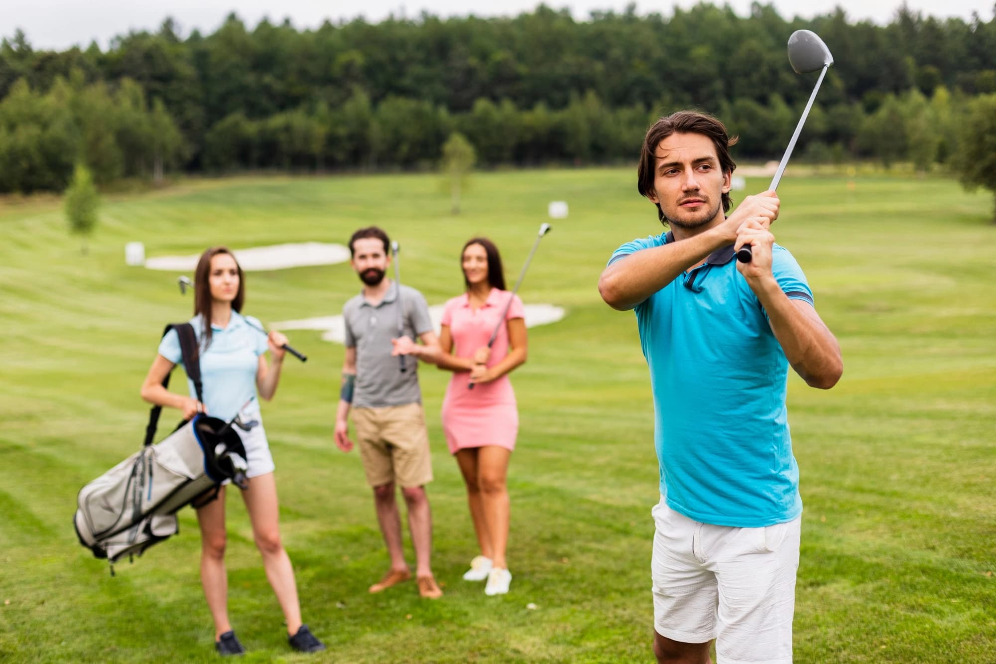 A golf instructor helping a student practice at Rise Golf Academy