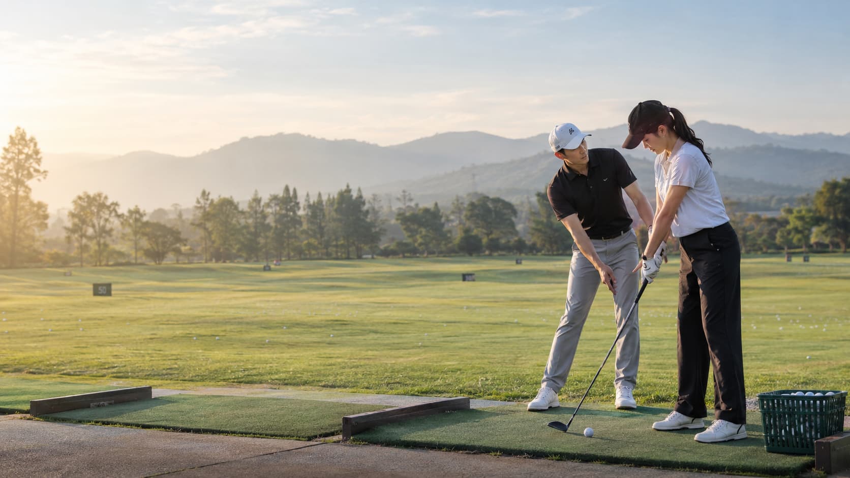 A golfer practicing with guidance from an instructor